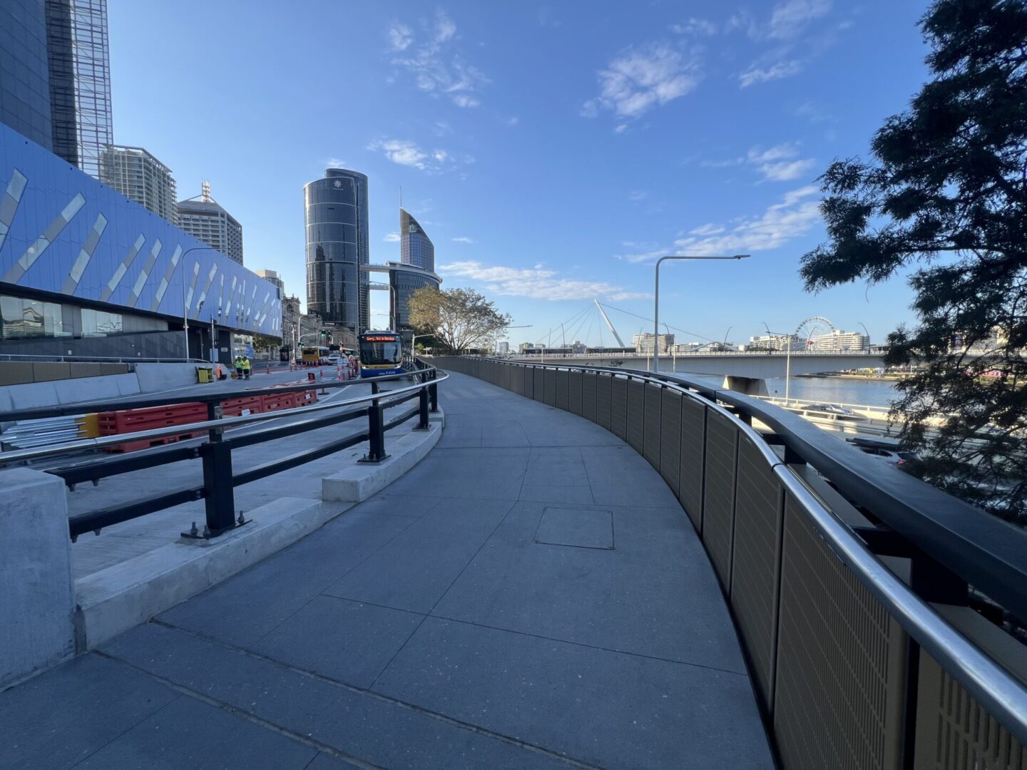 City waterfront path with modern buildings.
